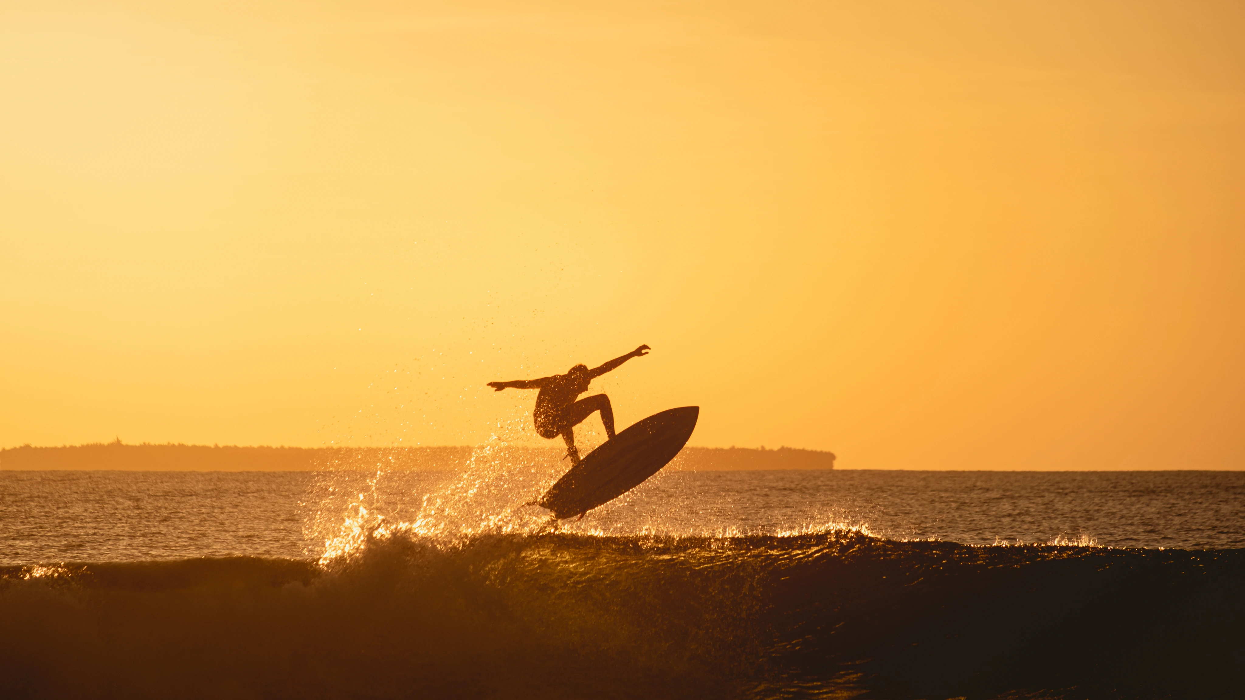 Surfer riding a wave wearing premium surf gear